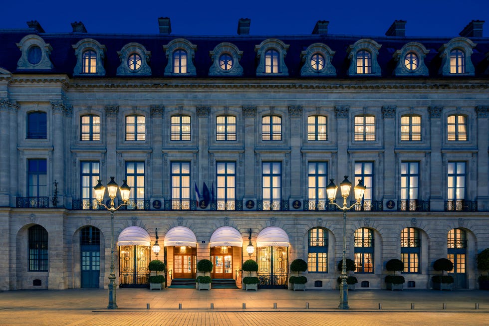 Facade of a hotel building with illuminated windows and entrance