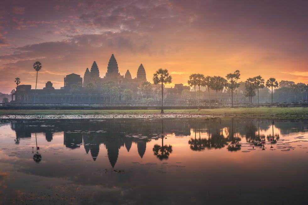 River cruises sunrise view of popular tourist attraction ancient temple complex angkor wat with reflected in lake siem reap, cambodia
