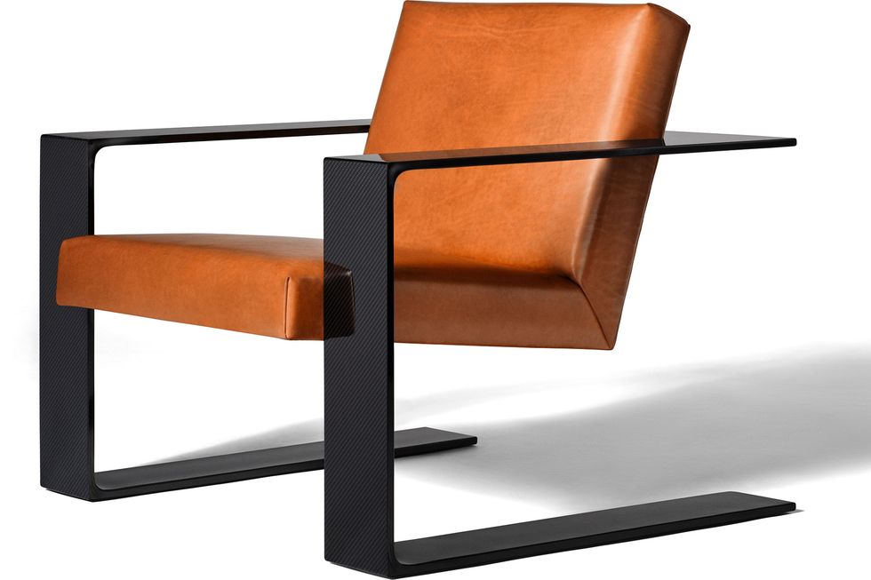 a close up of a classic rl chair in a dark taupey brown leather and black frame