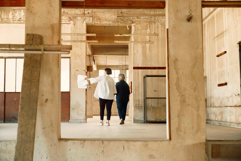 two women walking through a building