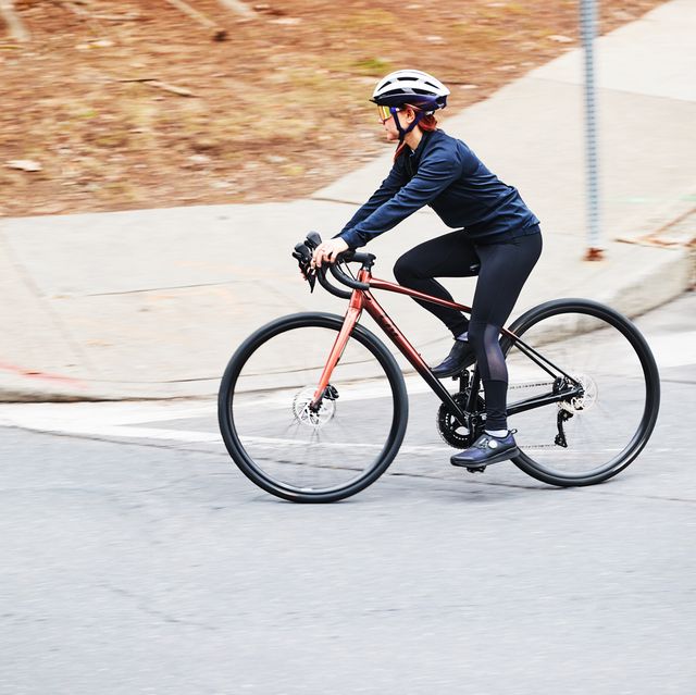 cycling tips a person riding a bicycle on a road around a corner