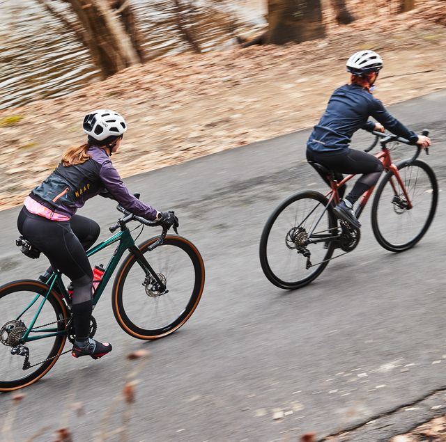 two people riding road bikes up a climb