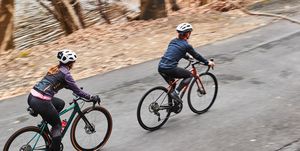 two people riding road bikes up a climb