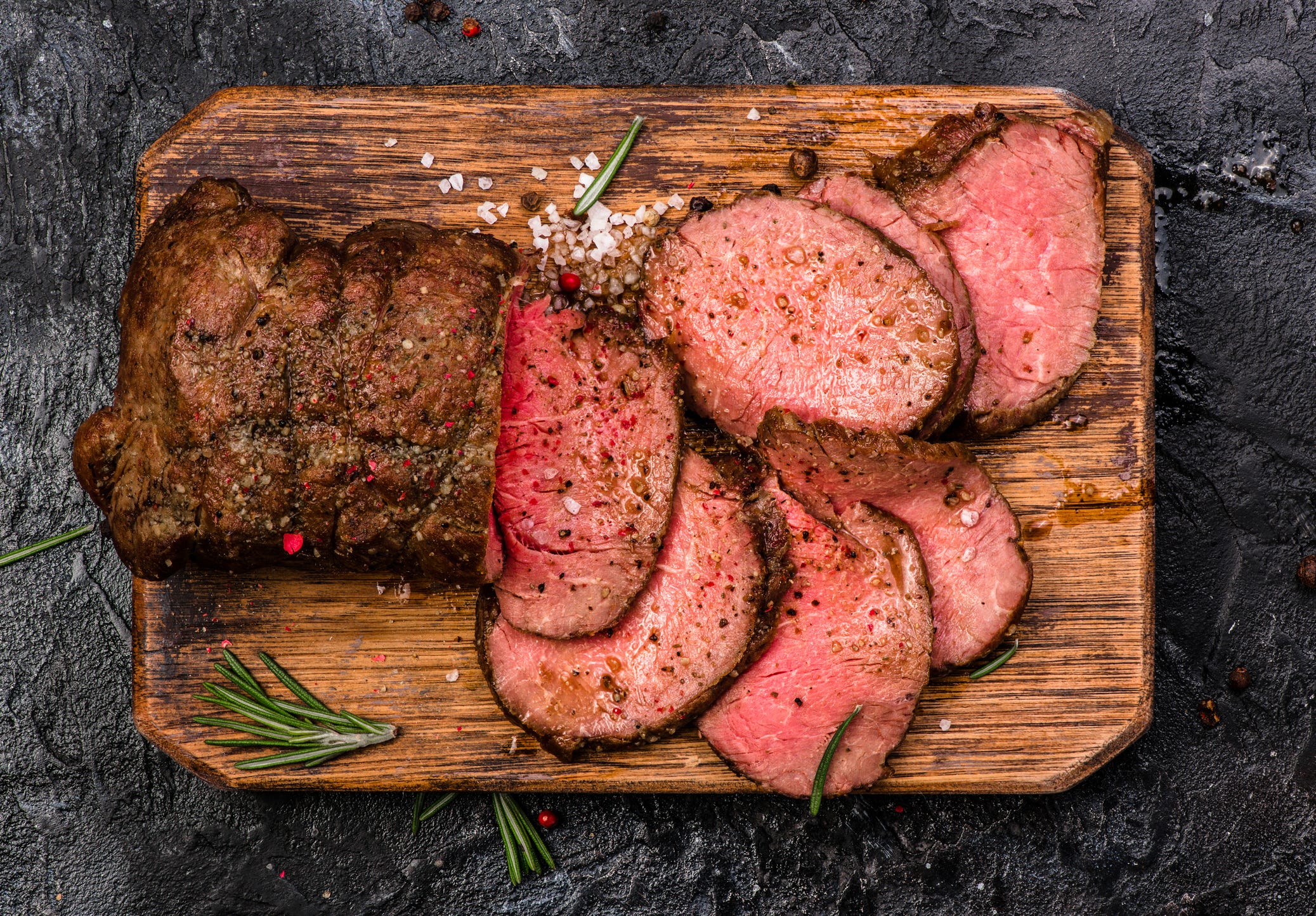 Roast Beef On Cutting Board With Salt And Pepper. Top View.