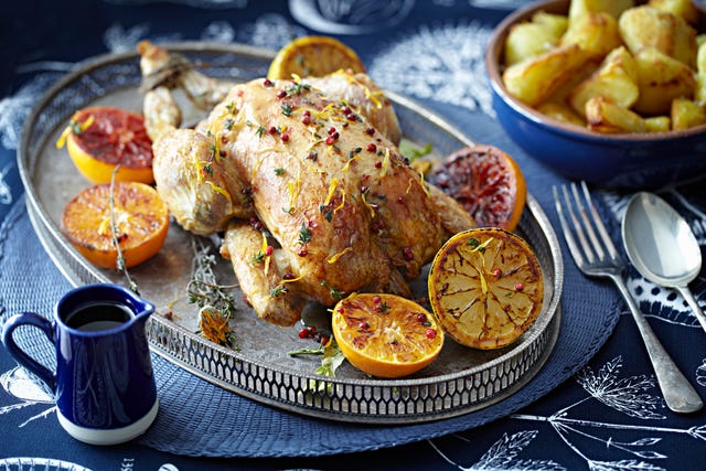roast chicken with glazed citrus fruits on serving tray