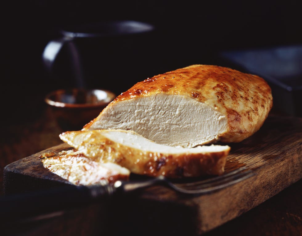 Roast turkey breast on rustic wooden chopping board