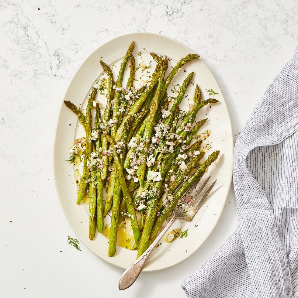 roasted asparagus salad with feta vinaigrette on a white plate