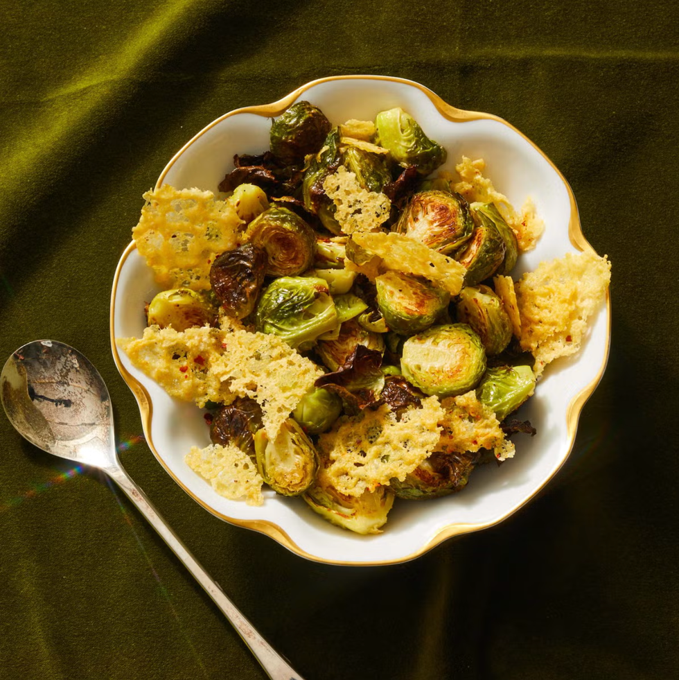 roasted brussels sprouts with parmesan crisps in a white bowl