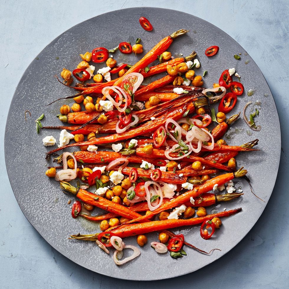 a plate of roasted carrots and chickpeas with marinated feta