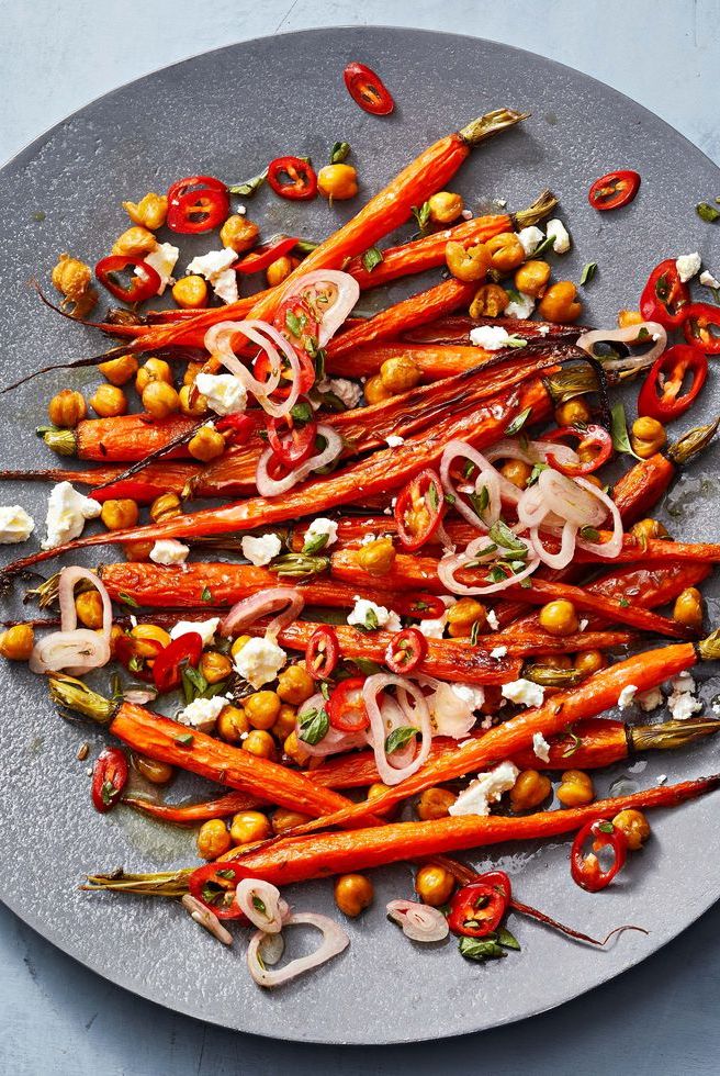 a plate of roasted carrots and chickpeas with marinated feta