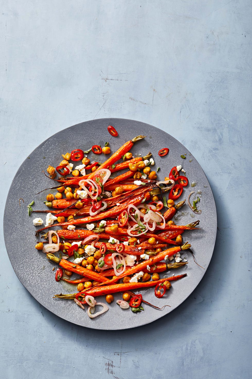 roasted carrots and chickpeas with marinated feta on a plate