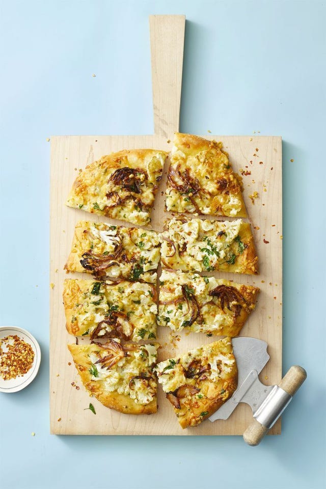 roasted cauliflower pizza on a wooden pizza peel