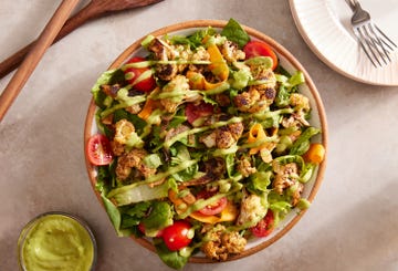 roasted cauliflower and mixed green and romaine salad topped with tomatoes, shaved carrots, and an avocado dressing