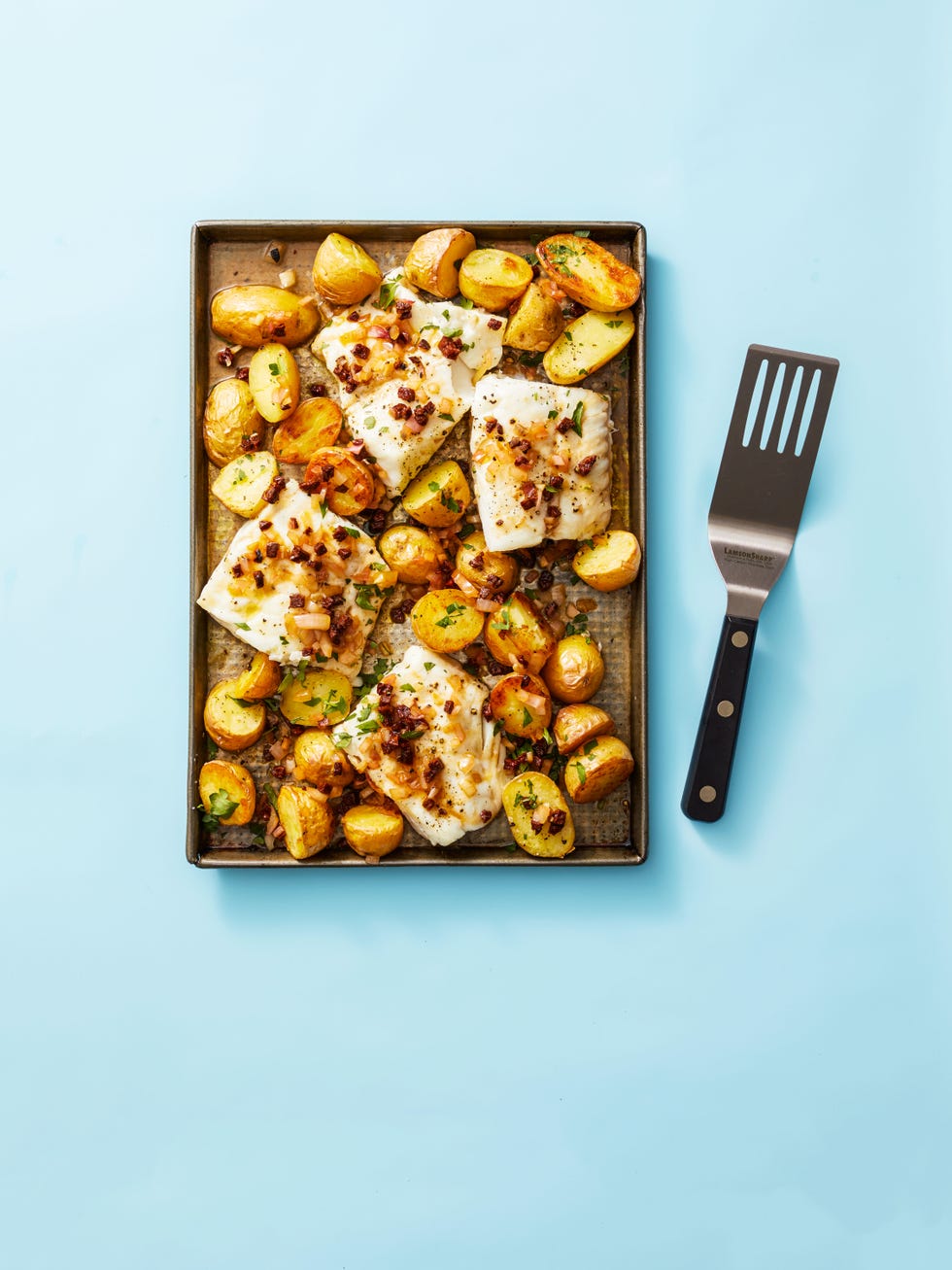 roasted cod and potatoes with chorizo vinaigrette on a sheet pan