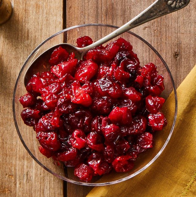 a bowl of cranberry sauce with spoon