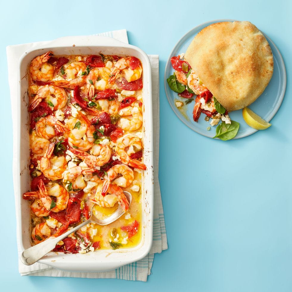 roasted garlicky shrimp in white pan on blue table