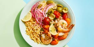 roasted mediterranean shrimp bowl with red onion, rice, tomatoes, olives and lemon