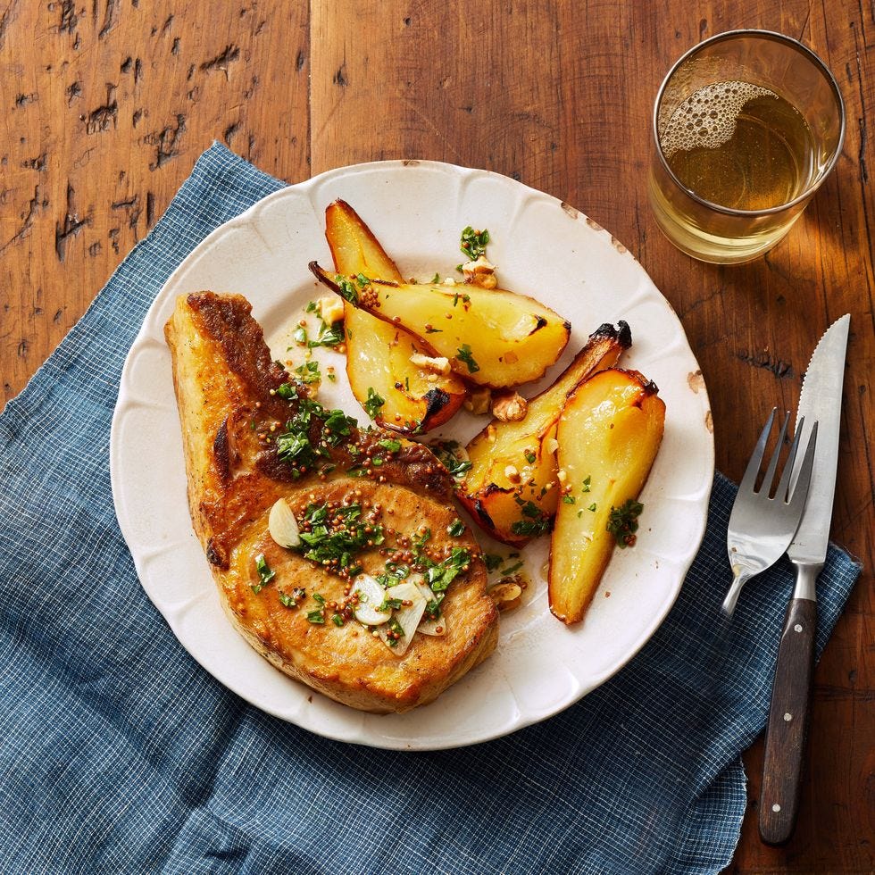 roasted pork chops and pears on a white plate