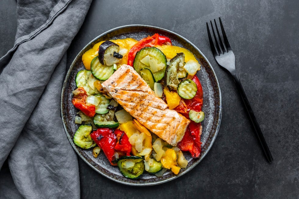 grilled salmon fillet served on a bed of colorful veg