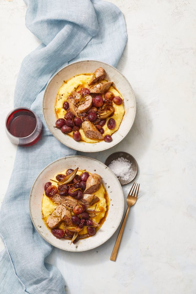 roasted sausage and grapes with salt on white background
