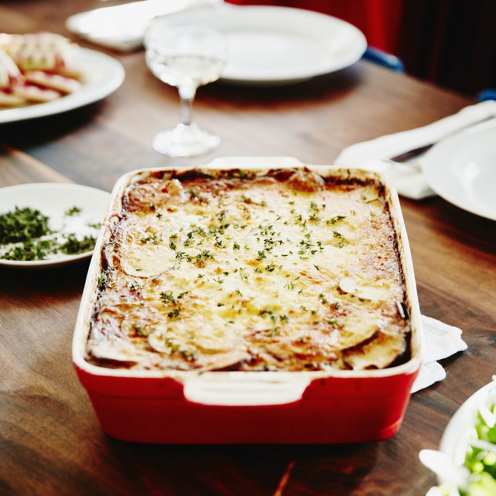 roasted scalloped potatoes in pan on table for holiday meal