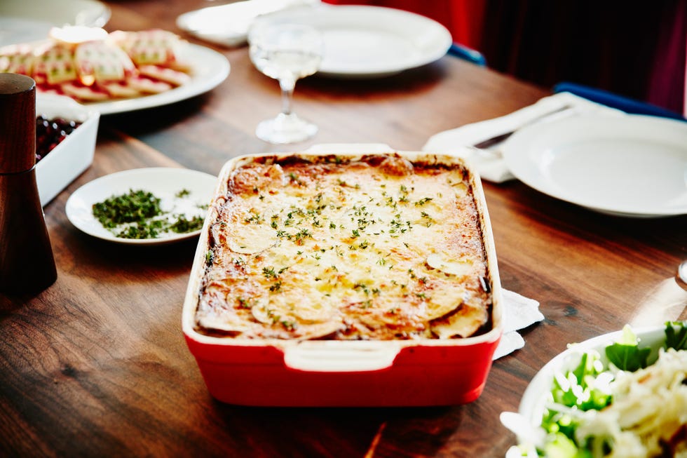 roasted scalloped potatoes in pan on table for holiday meal