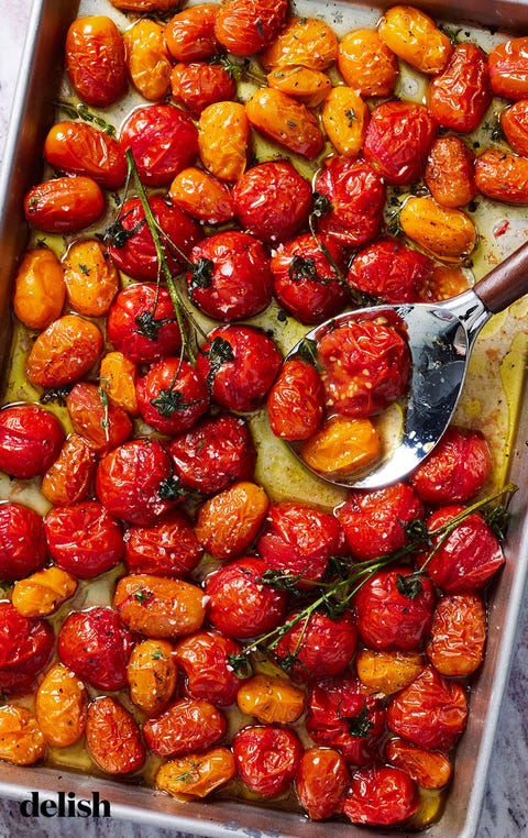 roasted tomatoes roasted tomatoes on a sheet tray with flaky sea salt and black pepper
