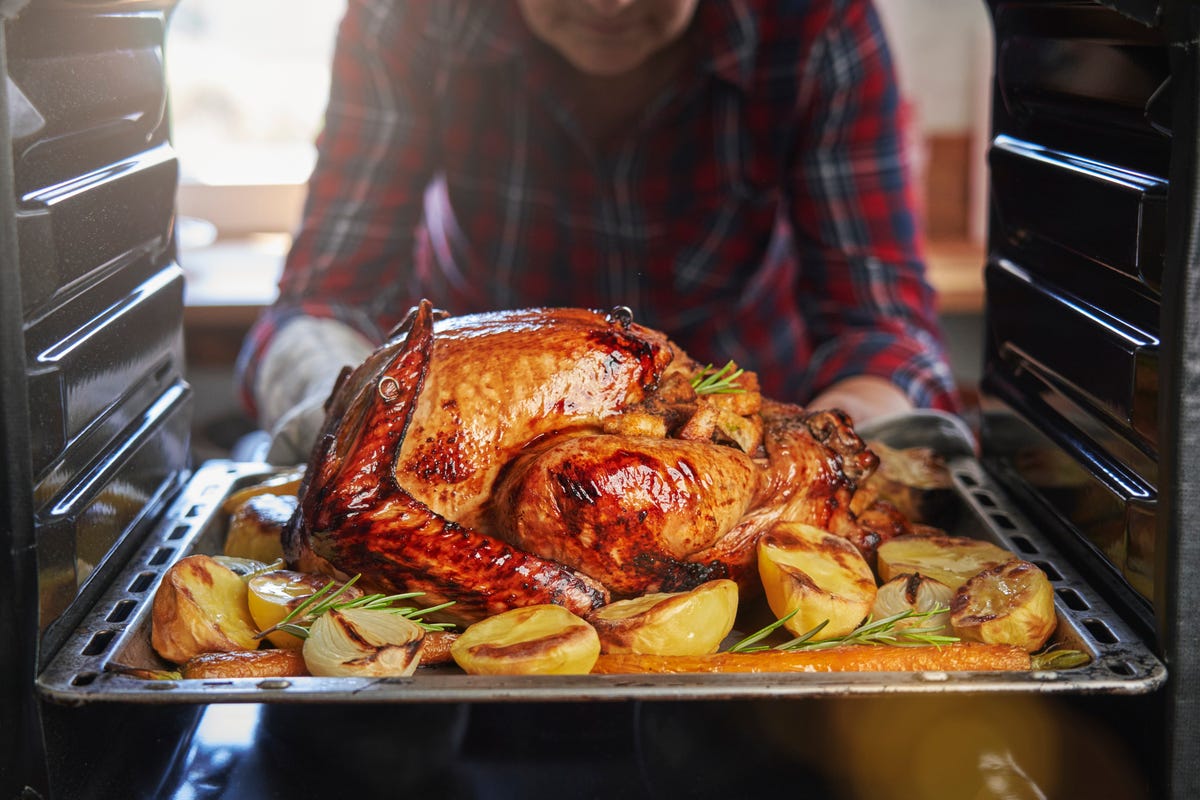 roasting turkey in the oven for holiday dinner