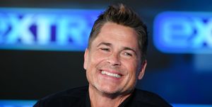 rob lowe smiles while visiting extra at burbank studios