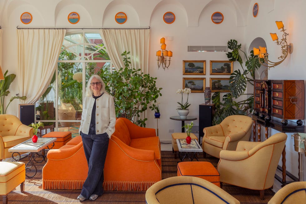 living room with a modern aesthetic featuring plants and orange furniture