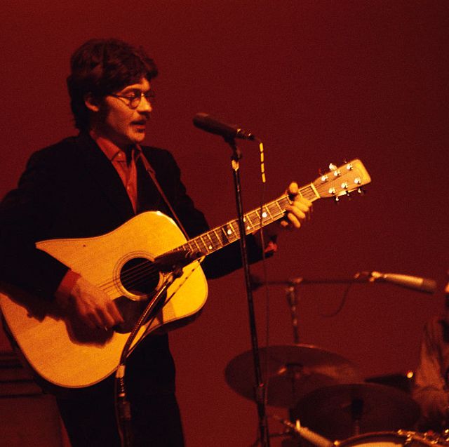 robbie robertson performing with the band at queens college