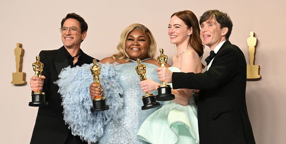 a group of people holding trophies