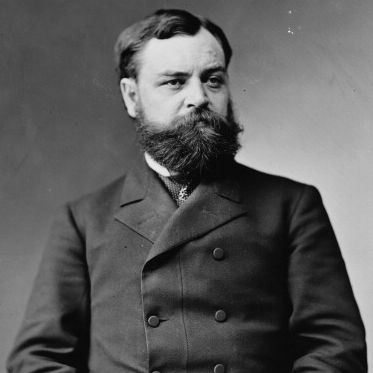 robert todd lincoln in a black and white portrait, he has a bushy full beard and wears a peacock