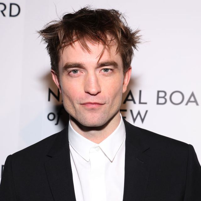 robert pattinson poses in black suit