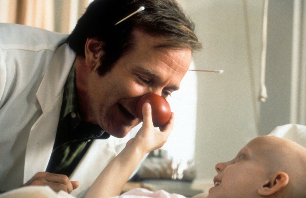 Robin Williams visits a sick child in a scene from the film 'Patch Adams', 1998