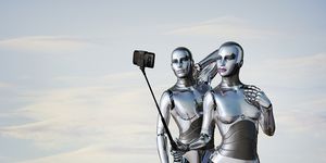 Robot couple posing for cell phone selfie