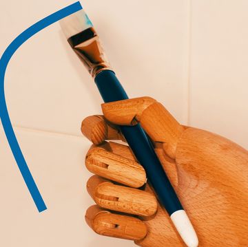 robot hand holding a paint brush