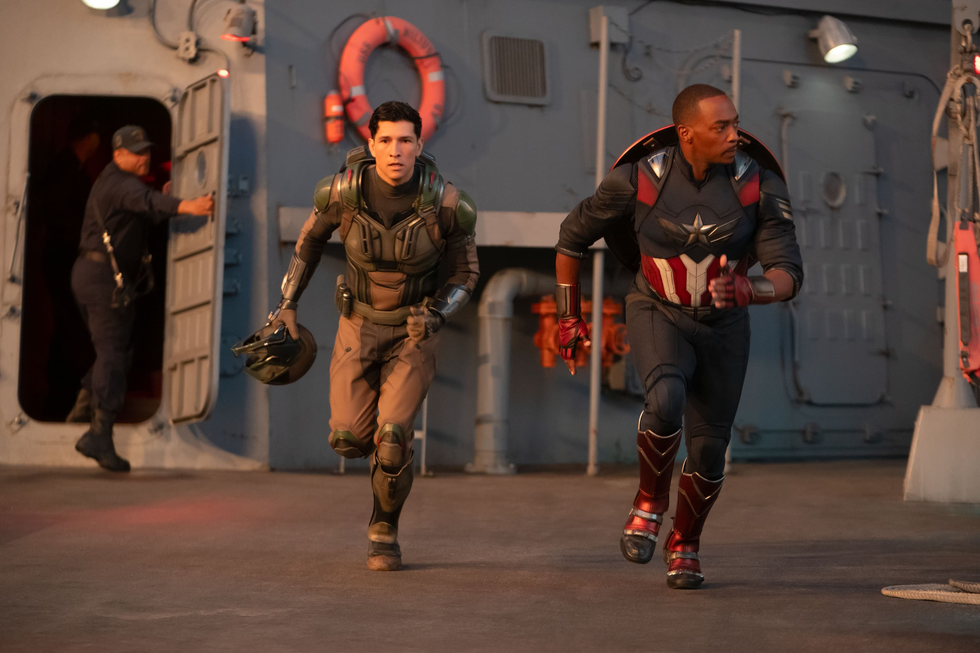 two superheroes in action on a ship deck