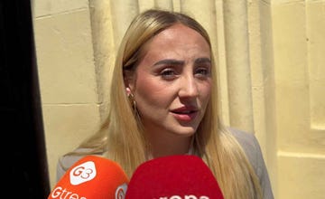 a woman being interviewed by media representatives