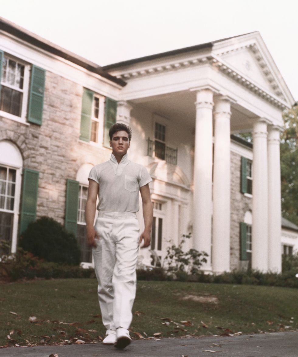 elvis presley walking on front of his graceland home