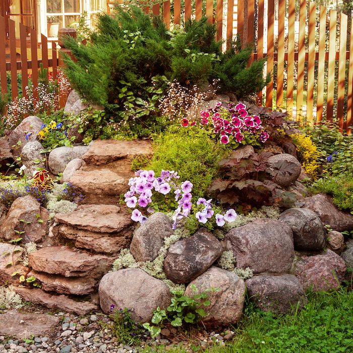rock garden made of large stones of different types of flowers
