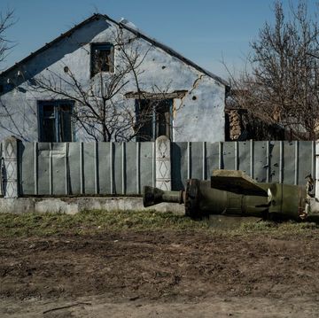 unexploded rocket laying in front of a damaged home in mykolaiv, ukraine