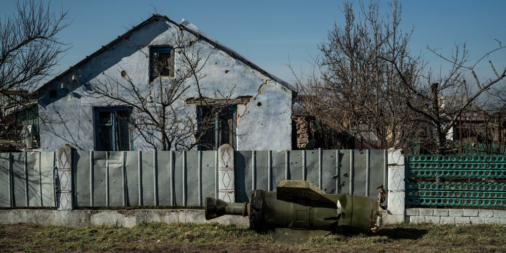 unexploded rocket laying in front of a damaged home in mykolaiv, ukraine