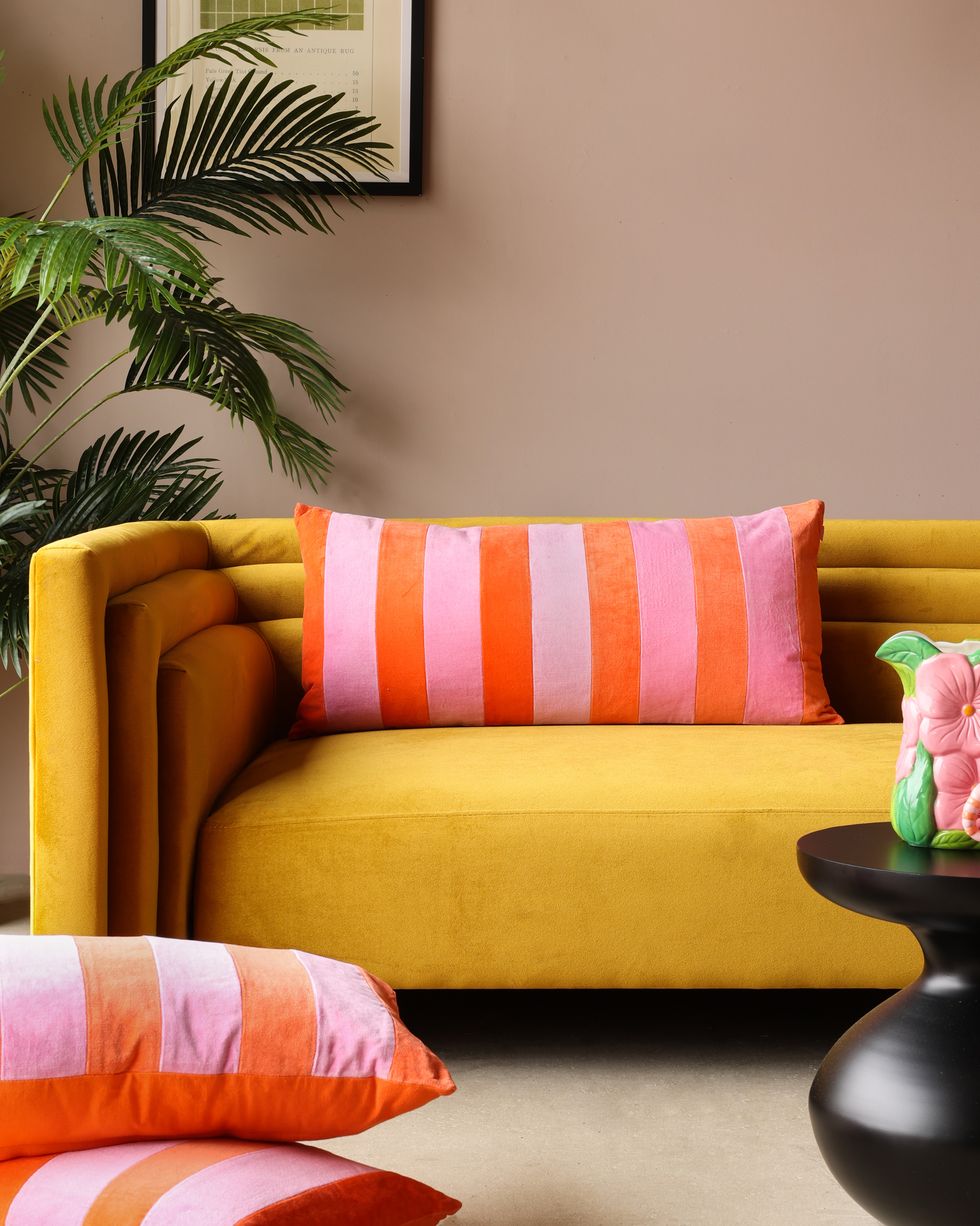 rockett st george, orange pink velvet rectangular cushion wes anderson style interiors pastel colourful retro yellow sofa bright cushions living room