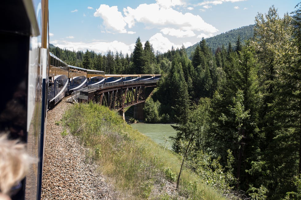 rocky mountaineer goldleaf service travelling over a bridge on journey through the clouds