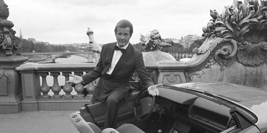 british actor roger moore on set of the james bond movie 'a view to a kill' with half a car during filming in paris, france in august 1984 photo by larry ellisexpressgetty images
