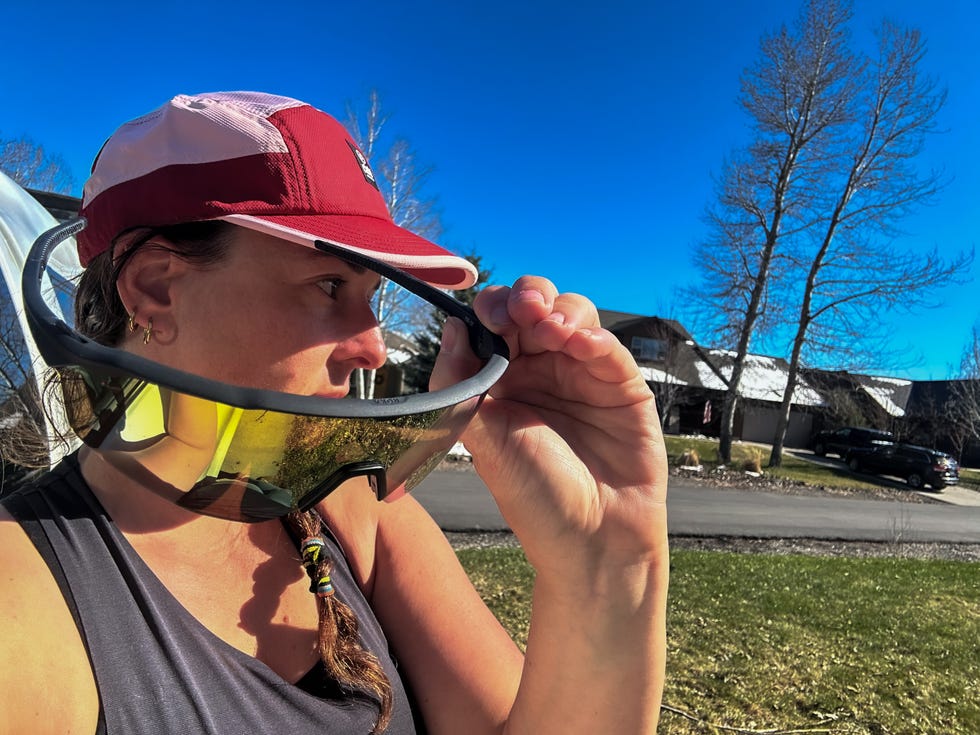 Person wearing sunglasses and a cap outdoors