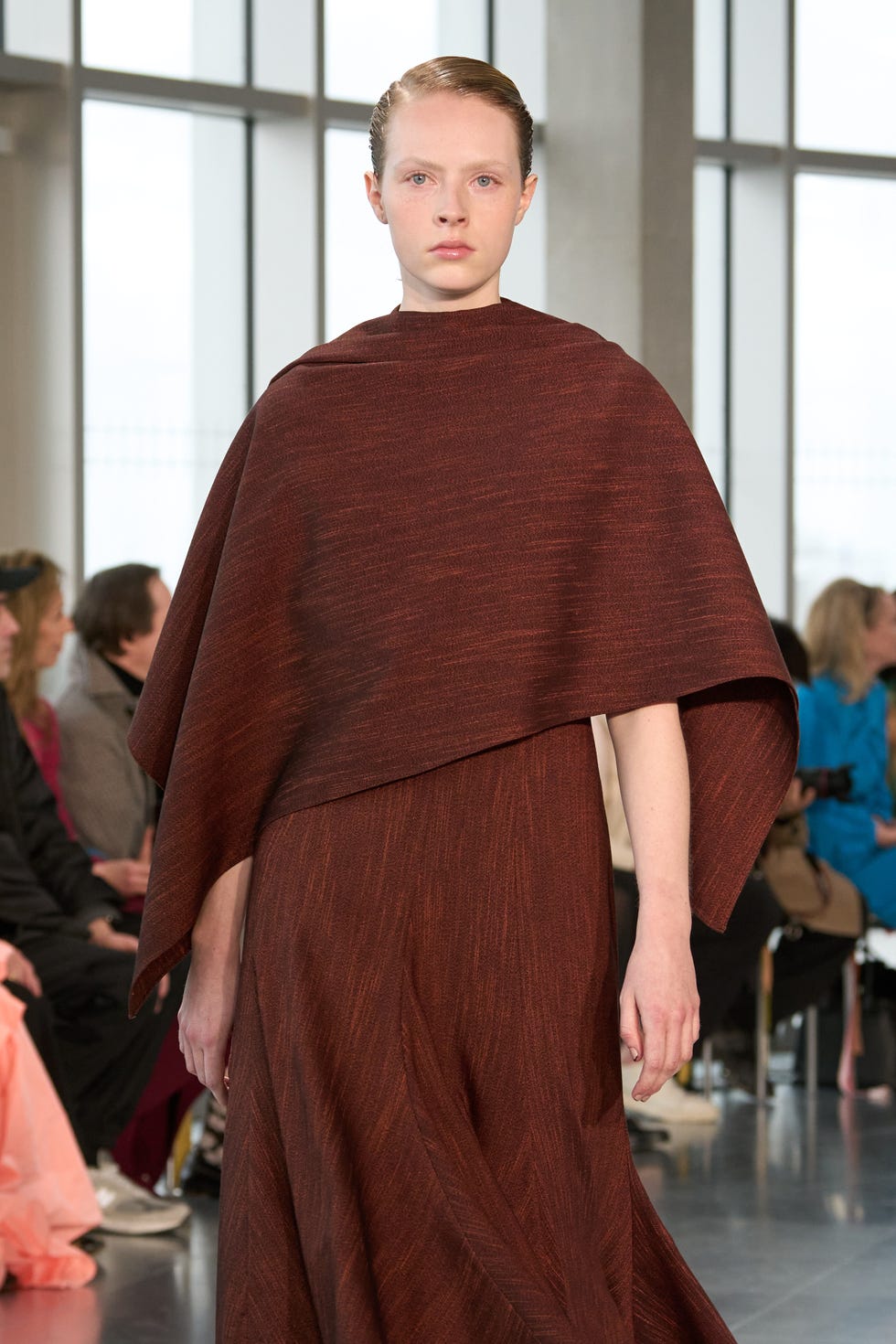 fashion show outfit featuring a model in a brown garment