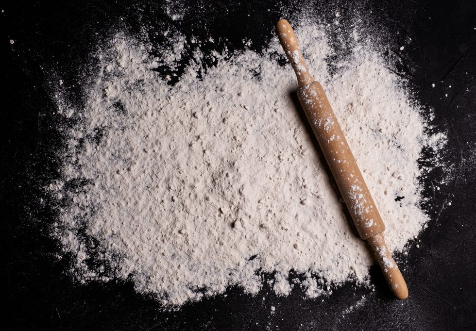 rolling pin on floured kitchen worktop