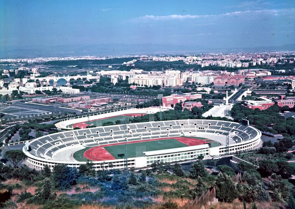 a large stadium with a field in front of it